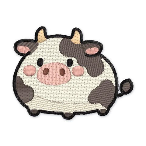 Ricamo a macchina di una mucca cicciottella avorio con macchie scure, corna nocciola, orecchie e muso rosa e guance arrossate